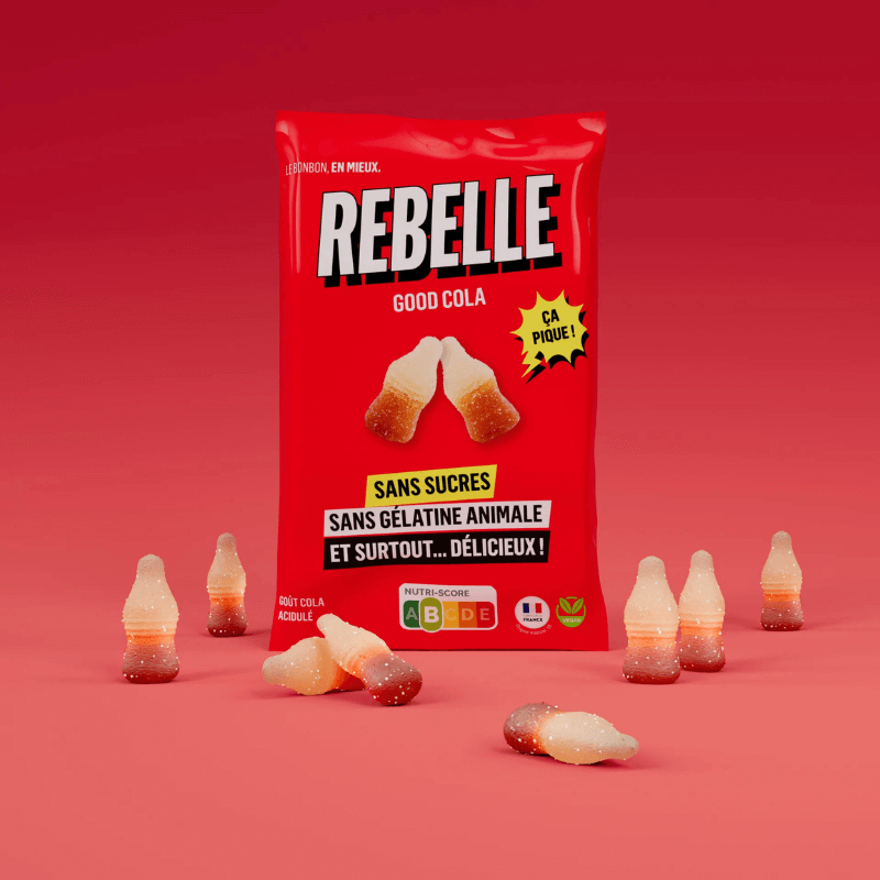 Sachet rouge de bonbons Rebelle Good Cola sans sucres ni gélatine animale entouré de bonbons en forme de bouteille sur fond rouge
