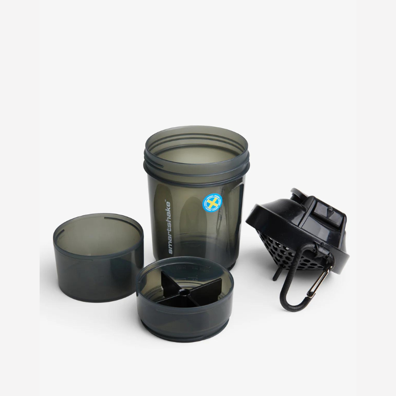 Shaker Smartshake 600 ml noir démonté montrant le gobelet, deux compartiments de stockage, le couvercle avec mousqueton et le filtre mélangeur